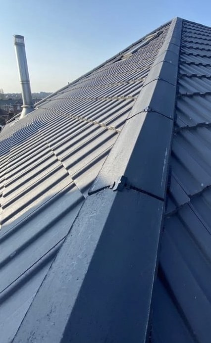 Same roof after Waypost re-roof — new dark interlocking tiles, fresh leadwork