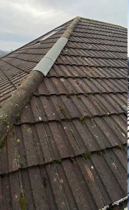 Roof before Waypost re-roof — worn red tiles, mossy ridges