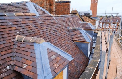 Lead flashings and valleys on a tiled Kent roof with chimney detail