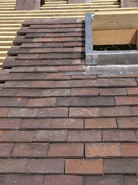 Hand-laid clay tile work in progress with new lead flashing